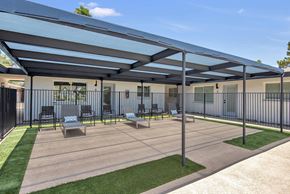 Phoenix apartment for rent - a patio with chairs and awning in front of a building