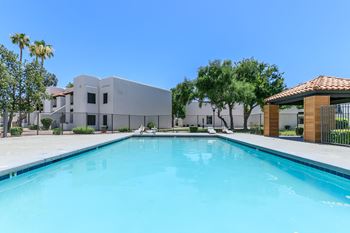 Large soothing swimming pool with wood-look cabana