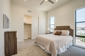 Scottsdale townhouse for rent - a bedroom with a large bed and a ceiling fan
