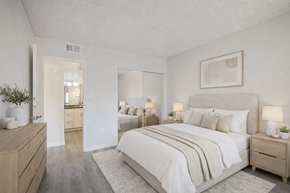 Phoenix apartment for rent - A well-lit bedroom with a large bed and a dresser.