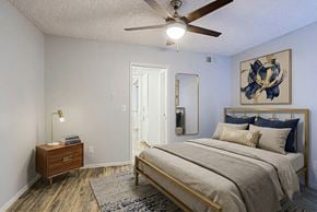 Mesa apartment for rent - A bedroom with a bed, nightstand, and artwork on the wall.