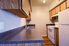Mesa apartment for rent - A kitchen with a white refrigerator and a white oven at Gilbert Square Apartments, Mesa, AZ