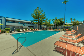 Mesa apartment for rent - A pool surrounded by sun loungers and palm trees at Gilbert Square Apartments, Mesa, 85203