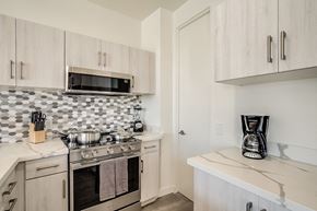 Scottsdale townhouse for rent - a kitchen with a stove and microwave and a counter top