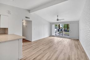 Phoenix apartment for rent - a living room with white walls and a sliding glass door to a patio