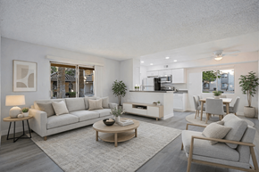 Phoenix apartment for rent - A modern living room with a grey sofa, wooden coffee table, and a grey armchair.