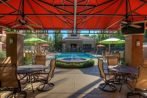 Phoenix apartment for rent - a patio with tables and chairs and a swimming pool