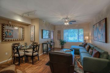 Phoenix apartment for rent - a living room with a couch and a table and a ceiling fan