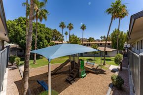Phoenix apartment for rent - A blue umbrella shades a playground.