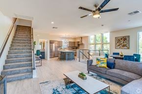 Tempe townhouse for rent - a living room with a staircase and a ceiling fan