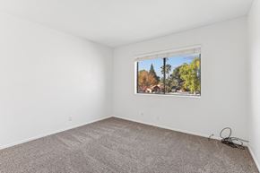 Wickenburg townhouse for rent - A room with a window showing a view of trees and houses outside.