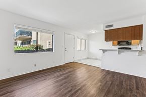 Wickenburg townhouse for rent - A room with wooden floors and a window showing an outdoor balcony.