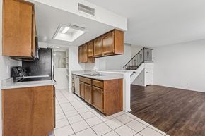 Wickenburg townhouse for rent - A kitchen with wooden cabinets and a black refrigerator.