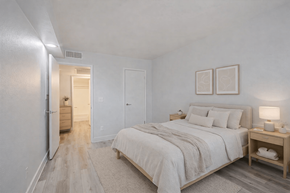 Phoenix apartment for rent - A bedroom with a large bed and a nightstand.