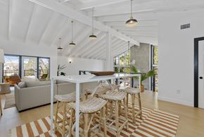 Flagstaff apartment for rent - A white dining room with a long table and chairs.