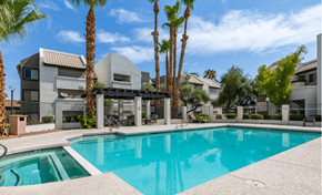 Glendale apartment for rent - a swimming pool with palm trees in front of an apartment building