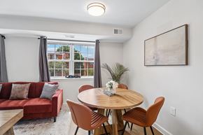 Washington apartment for rent - A dining room with a round table and chairs.