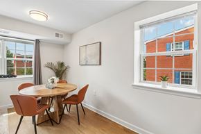 Washington apartment for rent - A dining room with a round table and chairs.