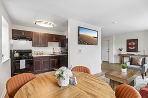 Washington apartment for rent - A modern kitchen with a wooden table set for a meal.