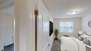 Washington apartment for rent - bedroom with bed, nightstand, tv, window and lighting at manor village  tax credit apartments in washington dc