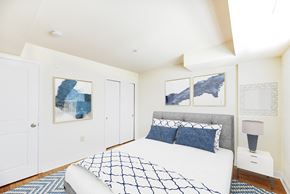 Washington apartment for rent - bedroom with bed, nightstand, and closet at jasper place apartments in washington dc