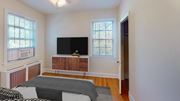 Washington apartment for rent - a bedroom with a bed and a television