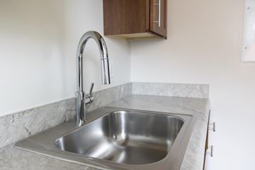 Washington apartment for rent - A stainless steel kitchen sink with a chrome faucet.