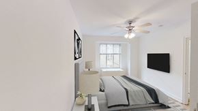 Washington apartment for rent - bedroom with bed, nightstands, large window and ceiling fan at 2800 woodley apartments in washington dc