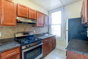Washington apartment for rent - kitchen with tile flooring, wood cabinetry, energy efficient appliances, gas range and window at the cortland apartments in washington dc