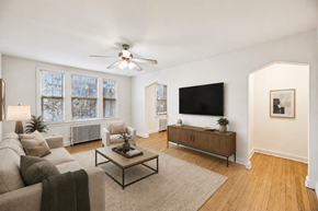 Washington apartment for rent - A living room with a couch, a coffee table, and a flat screen TV.