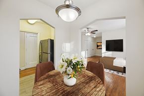 Washington apartment for rent - A dining room with a wooden table and chairs.