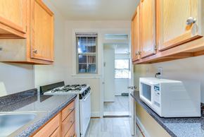Washington apartment for rent - kitchen with gas range, wood cabinetry and energy efficient appliances at 4020 calvert street apartments in washington dc
