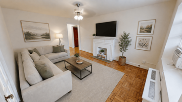Washington apartment for rent - A living room with a grey couch, a coffee table, a fireplace, and a painting on the wall.