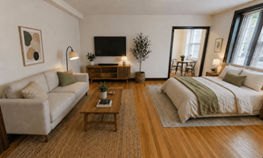 Washington apartment for rent - A living room with a couch, coffee table, and a bed.
