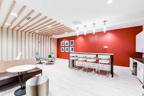 Washington apartment for rent - resident lounge with social seating, tables, and catering kitchen at archer park apartments in southeast Washington dc