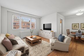 Bethesda apartment for rent - A living room with a couch, a coffee table, and a television.