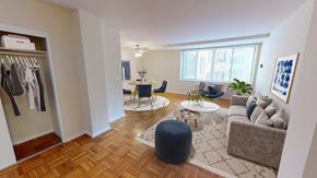 Washington apartment for rent - A well-lit, spacious living room with a wooden floor and a large window.