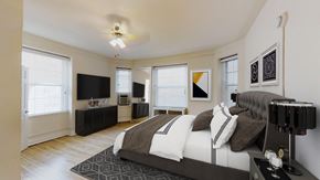 Washington apartment for rent - bedroom with bed, dresser, night stands, tv, ceiling fan and large windows at the calvertion apartments in washington dc