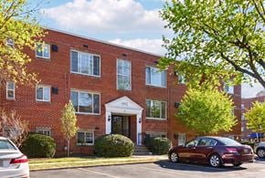 Bethesda apartment for rent - A red brick building with a white door and windows.
