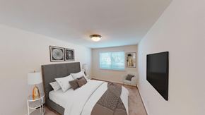 Bethesda apartment for rent - bedroom with bed, nightstands, large windows and tv at cambridge square apartments in bethesda md