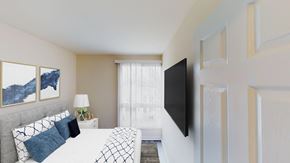 Washington apartment for rent - bedroom with bed, night stands, large windows and tv at city towns apartments in washington dc