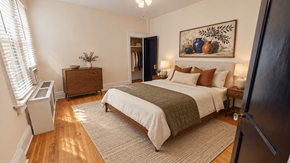 Washington apartment for rent - A bedroom with a large bed and a painting on the wall.