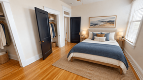 Washington apartment for rent - A bedroom with a bed, a wardrobe, and a painting on the wall.