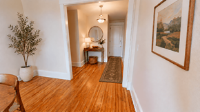 Washington apartment for rent - A hallway with a wooden floor and a painting on the wall.