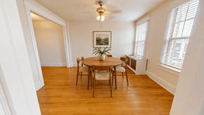 Washington apartment for rent - A dining room with a wooden table and chairs.