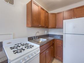 Washington apartment for rent - kitchen with refrigerator, gas range and tile flooring at 6100 14th Street apartments in washington dc