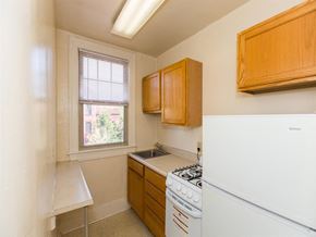 Washington apartment for rent - kitchen with refrigerator, gas range, breakfast bar and window at the foreland apartments in capitol hill washington dc