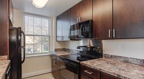 Washington apartment for rent - kitchen with espresso cabinetry, window and energy efficient appliances at juniper courts apartments in takoma washington dc