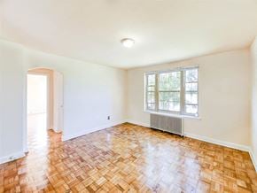 Washington apartment for rent - vacant living area with hardwood floors, view of bedroom and large windows at randle circle apartments in washington dc