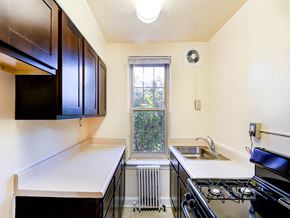 Washington apartment for rent - kitchen with espresso cabinets, gas range and window at randle circle apartments in washington dc